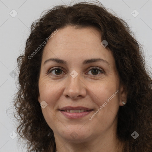 Joyful white adult female with long  brown hair and brown eyes