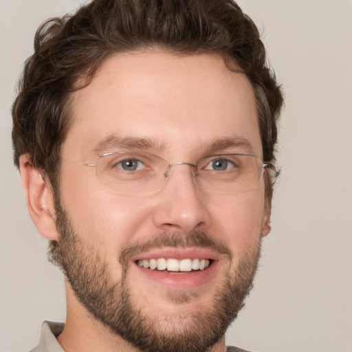 Joyful white adult male with short  brown hair and green eyes