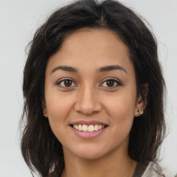 Joyful latino young-adult female with long  brown hair and brown eyes