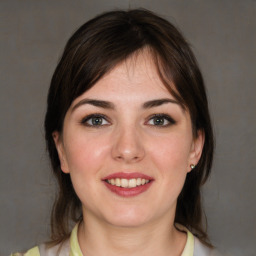 Joyful white young-adult female with medium  brown hair and brown eyes