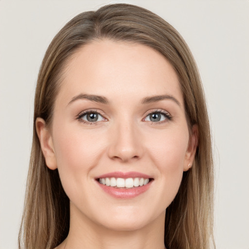 Joyful white young-adult female with long  brown hair and grey eyes