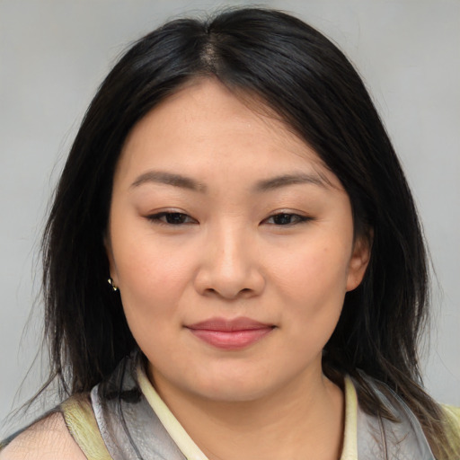 Joyful asian young-adult female with medium  brown hair and brown eyes