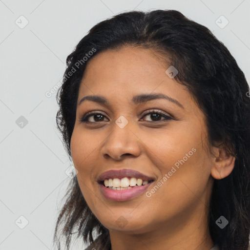 Joyful latino young-adult female with long  black hair and brown eyes