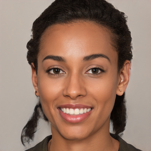 Joyful latino young-adult female with short  black hair and brown eyes