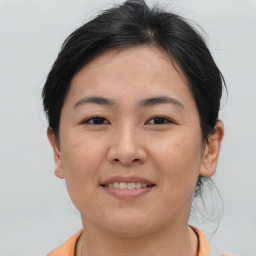 Joyful asian young-adult female with short  brown hair and brown eyes