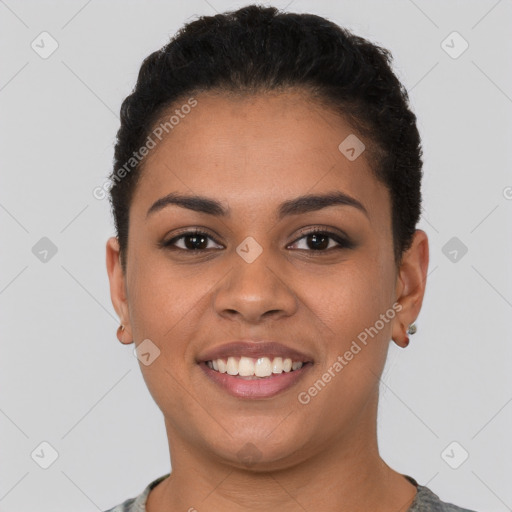 Joyful latino young-adult female with short  brown hair and brown eyes