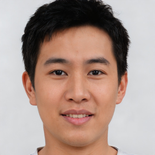 Joyful asian young-adult male with short  brown hair and brown eyes