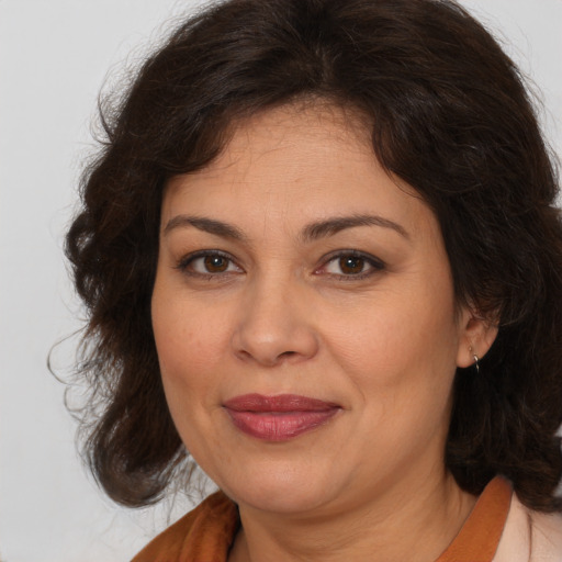 Joyful white adult female with medium  brown hair and brown eyes