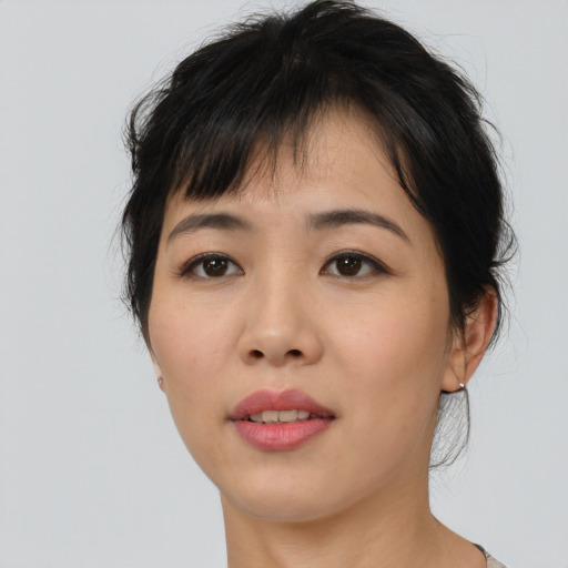 Joyful asian young-adult female with medium  brown hair and brown eyes