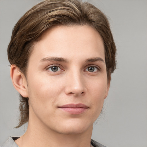 Joyful white young-adult female with short  brown hair and grey eyes