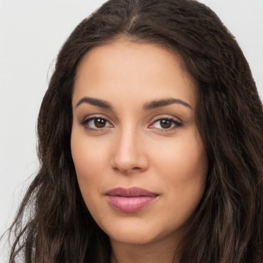 Joyful latino young-adult female with long  brown hair and brown eyes