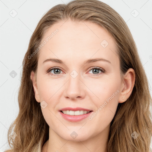 Joyful white young-adult female with long  brown hair and blue eyes