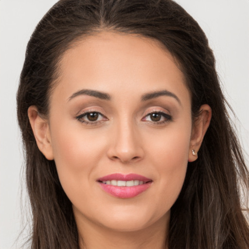 Joyful white young-adult female with long  brown hair and brown eyes