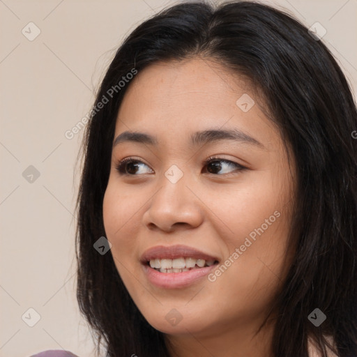 Joyful asian young-adult female with long  brown hair and brown eyes