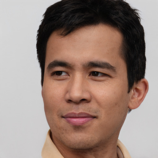 Joyful asian young-adult male with short  brown hair and brown eyes