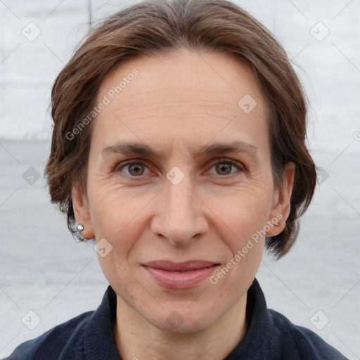 Joyful white adult female with medium  brown hair and grey eyes