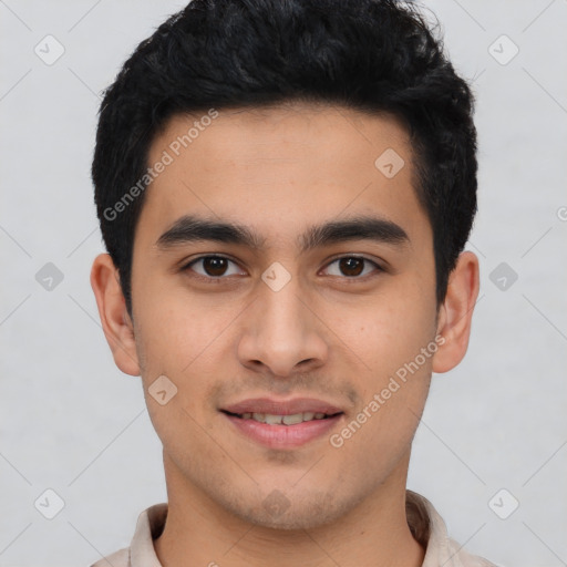 Joyful latino young-adult male with short  black hair and brown eyes