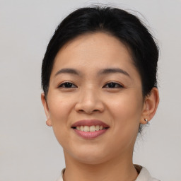 Joyful asian young-adult female with short  brown hair and brown eyes