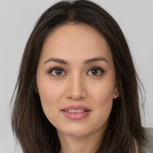 Joyful white young-adult female with long  brown hair and brown eyes