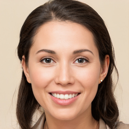 Joyful white young-adult female with long  brown hair and brown eyes