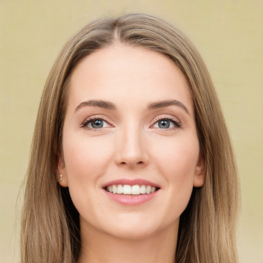 Joyful white young-adult female with long  brown hair and green eyes