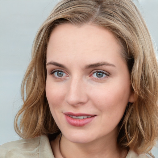 Joyful white young-adult female with medium  brown hair and blue eyes