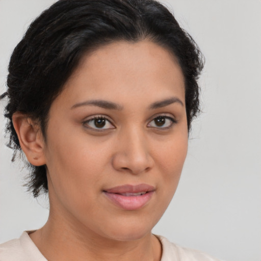 Joyful latino young-adult female with short  brown hair and brown eyes
