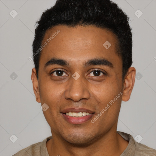 Joyful black young-adult male with short  black hair and brown eyes