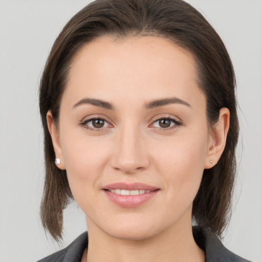 Joyful white young-adult female with medium  brown hair and brown eyes