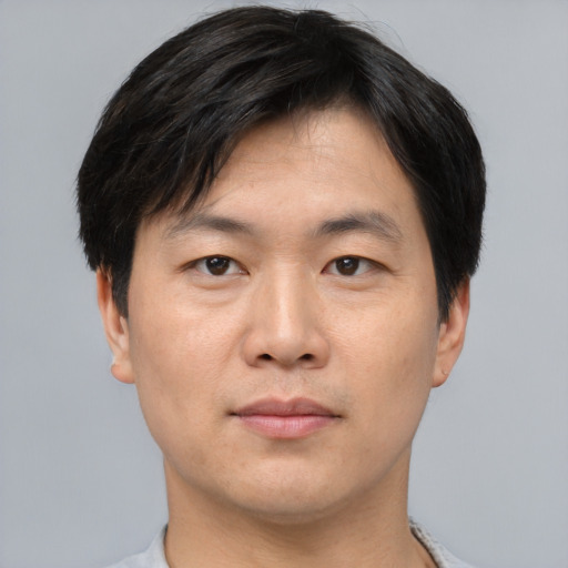 Neutral asian young-adult male with short  brown hair and brown eyes