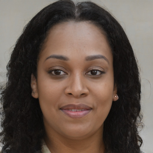 Joyful latino young-adult female with long  brown hair and brown eyes