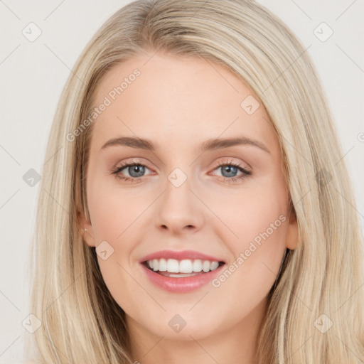 Joyful white young-adult female with long  brown hair and blue eyes