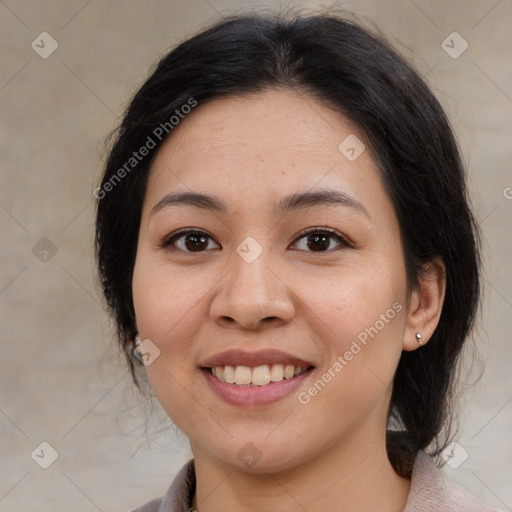 Joyful latino young-adult female with medium  brown hair and brown eyes