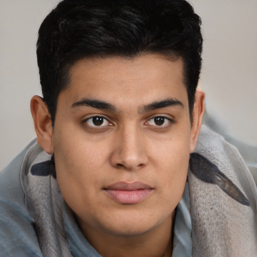 Joyful latino young-adult male with short  brown hair and brown eyes