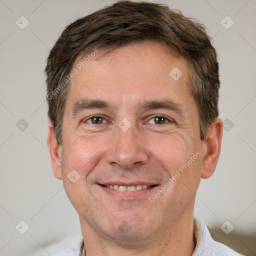 Joyful white adult male with short  brown hair and brown eyes