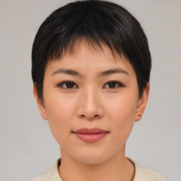 Joyful asian young-adult female with short  brown hair and brown eyes