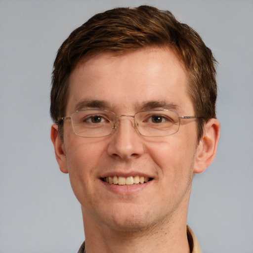 Joyful white adult male with short  brown hair and grey eyes