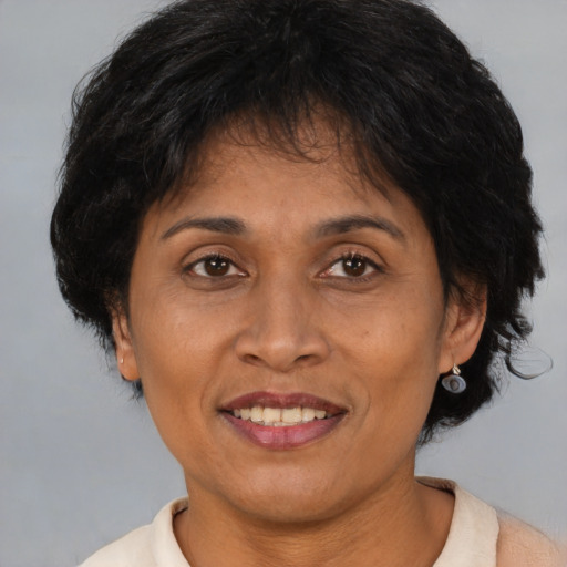 Joyful asian adult female with medium  brown hair and brown eyes