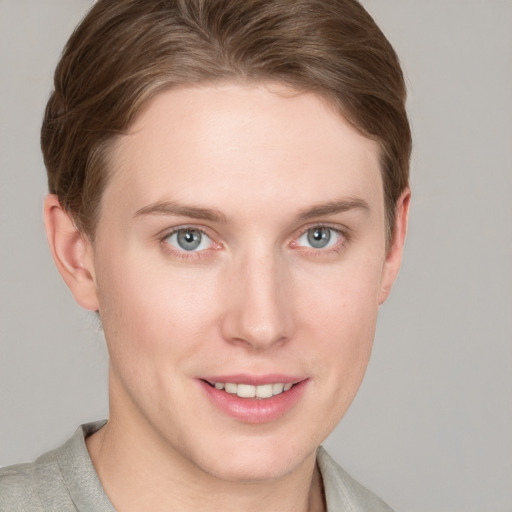 Joyful white young-adult female with short  brown hair and blue eyes