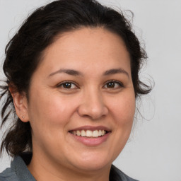 Joyful white adult female with medium  brown hair and brown eyes