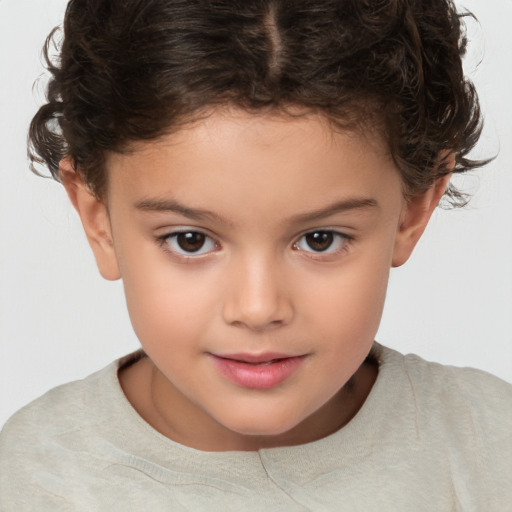 Joyful white child female with short  brown hair and brown eyes