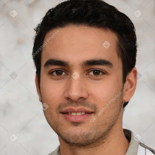 Joyful white young-adult male with short  black hair and brown eyes