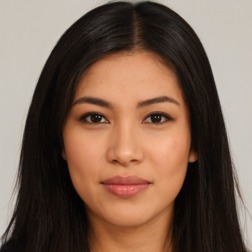 Joyful latino young-adult female with long  black hair and brown eyes