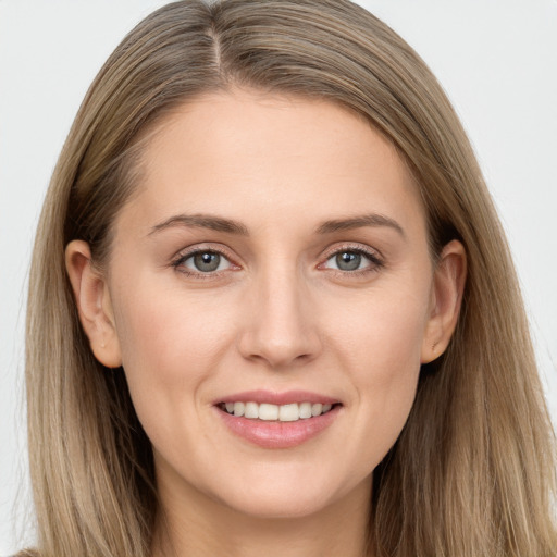 Joyful white young-adult female with long  brown hair and grey eyes