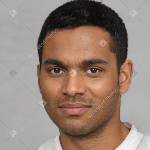 Joyful black young-adult male with short  black hair and brown eyes