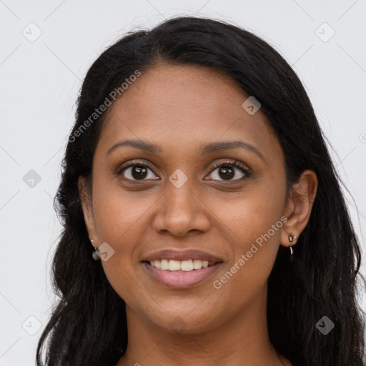 Joyful black young-adult female with long  brown hair and brown eyes