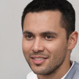 Joyful white young-adult male with short  black hair and brown eyes