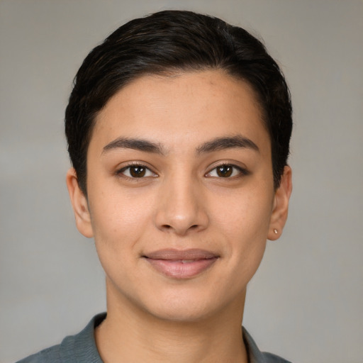 Joyful latino young-adult female with short  brown hair and brown eyes