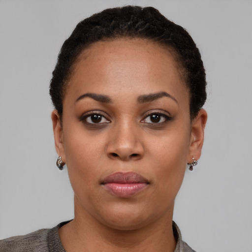 Joyful black young-adult female with short  brown hair and brown eyes