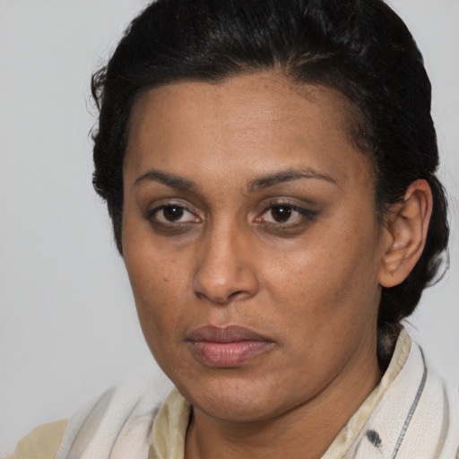 Neutral latino adult female with short  brown hair and brown eyes